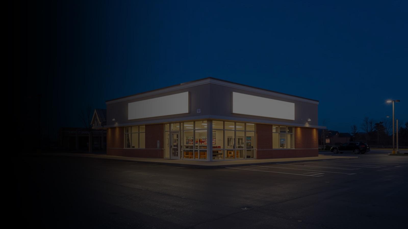 Single-tenant net-lease retail property at dusk